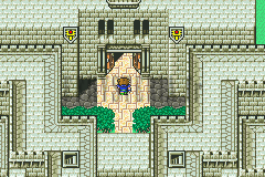 Le château de Karnak : la porte principale entre ses remparts clairs et ses bannières (version GBA)