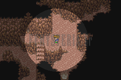 Une galerie de la Caverne des gils, roche brune éclairée par un halo autour du personnage (version GBA)