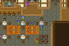 La taverne de Karnak : tables, tapis rouges et clients (version GBA)