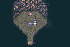 Une salle de sauvegarde de l’antre, en forme de grotte au bord de l’eau, avec un mog et le point de sauvegarde (version GBA)