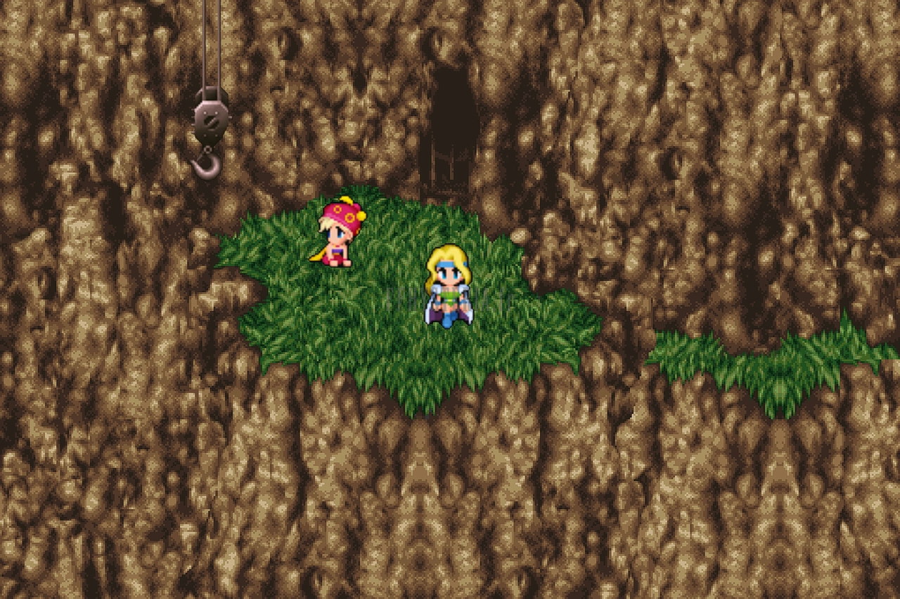 L’entrée de la Grotte du Phénix : une bande d’herbe au milieu des rochers bruns, deux personnages (version mobile/PC)