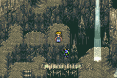 La grotte du Mont Zozo : cascade de lumière et pont de bois ; Sabin et une petite créature bleue sur le chemin (version GBA)
